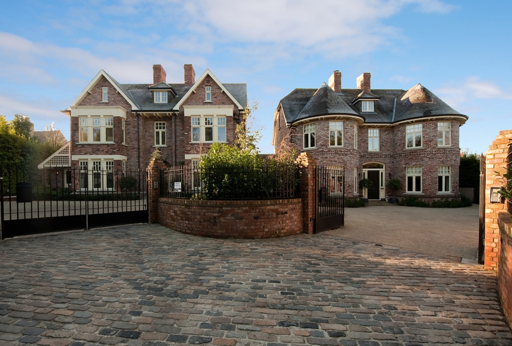 Pair of complementary salvaged brick finished dwellings with basalt cobbled entrance and bonded gravel forecourts