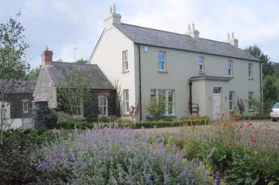 newly_built_rendered_cottage_with_wings_and_outbuildings_1